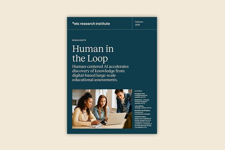 A view of a crowded classroom from the last row of seats. The background is blurred; the foreground shows a woman with her back to the camera, taking notes on her laptop.