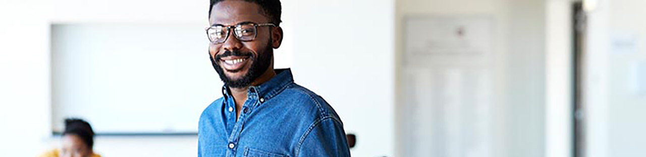 Man in blue shirt wearing glasses