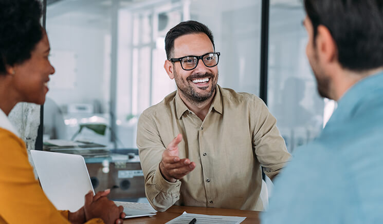A man wearing specs talking to other person