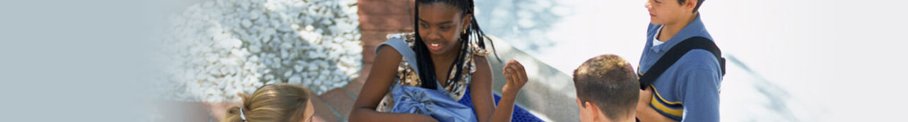 Students wearing backpacks and talking outside